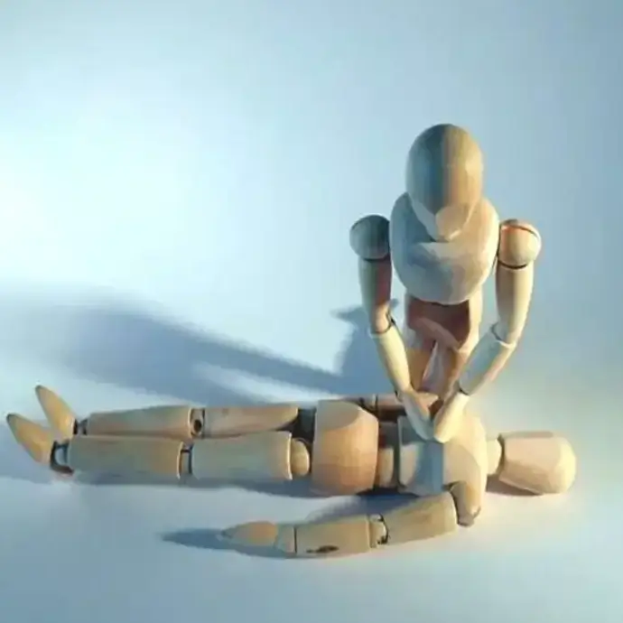 Wooden mannequin performing CPR, illustrating the preserve life principle in first aid.