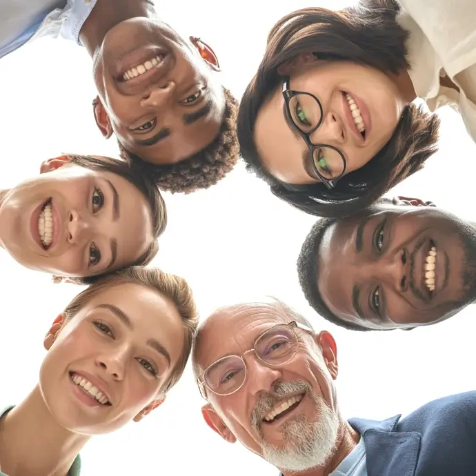 A diverse group of people staring down into a camera