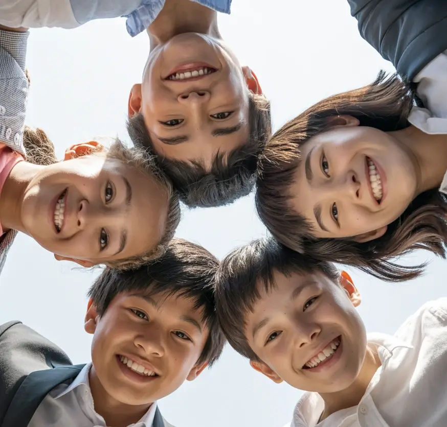 A diverse group of children staring down into a camera lens