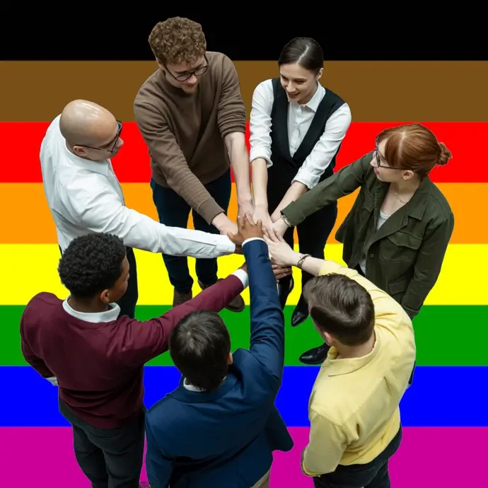 A diverse group of people linking hands