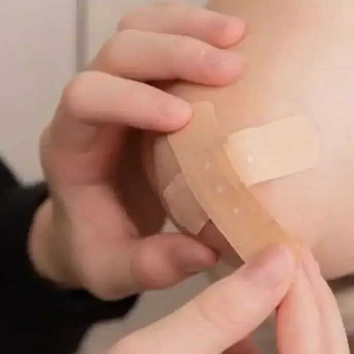 Applying a plaster to an injury, first aid at work course content.