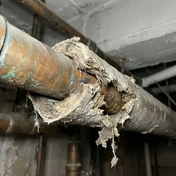 Old pipe insulated with asbestos pipe lagging