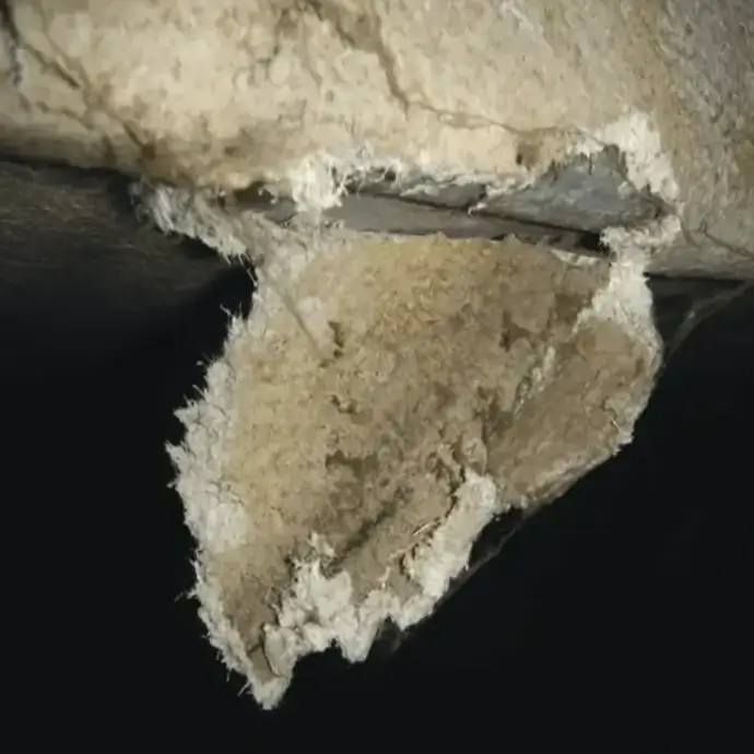 Damaged asbestos pipe lagging